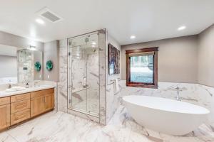 a white bathroom with a tub and a shower at Gondola Vista Luxury Villas by Ski Heavenly & Beaches in South Lake Tahoe +103 photos