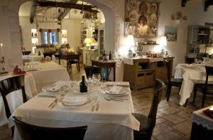 a dining room with tables with white tablecloths at Masseria Salinola in Ostuni