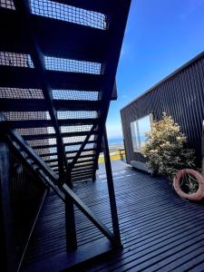 a balcony with a view of the ocean from a building at El Coo Lodge in Queilén