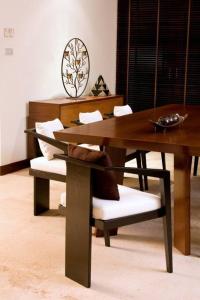 mesa de comedor y sillas con mesa de madera en Two-bedroom villa with pool, en Ban Ang Thong