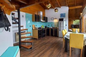 a kitchen and dining room with a table and a staircase at Cabaña de montaña en Cerro Otto con increible Vista al Lago in San Carlos de Bariloche +24 photos