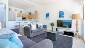 a living room with a couch and a table at Jervis Shores in Callala Bay