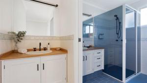 a bathroom with a sink and a shower at Warrahwillah in Currarong