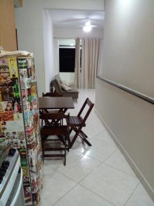 a kitchen with a refrigerator and a table and chairs at Kitnet Itapuã in Vila Velha