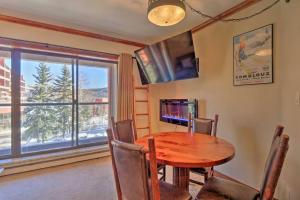a dining room with a wooden table and a window at Beaver Run Studio- Dog Friendly in Breckenridge