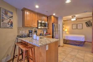 a kitchen with a counter and a room with a bed at Beaver Run Studio- Dog Friendly in Breckenridge