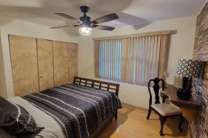 a bedroom with a bed and a ceiling fan at Special Vacation House/ Pool & Basketball Court in El Cajon