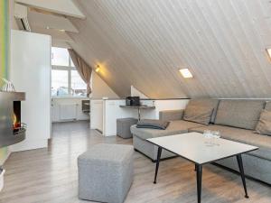 a living room with a couch and a table at Two-Bedroom Holiday home in Wendtorf 1 in Wendtorf