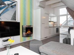 a kitchen and living room with a fireplace at Two-Bedroom Holiday home in Wendtorf 6 in Wendtorf
