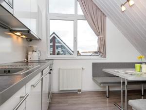 a small kitchen with a table and a window at Two-Bedroom Holiday home in Wendtorf 6 in Wendtorf
