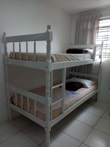 two bunk beds in a room with a window at Pousada da Sônia in Camaragibe