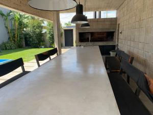 a large long table with chairs in a backyard at bunker in San Pedro