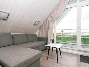a living room with a couch and a table at 6 person holiday home in Wendtorf in Wendtorf