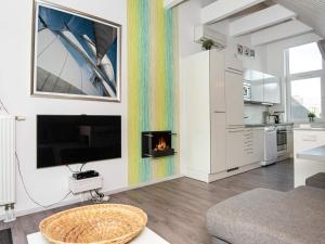 a living room with a fireplace and a kitchen at 6 person holiday home in Wendtorf in Wendtorf