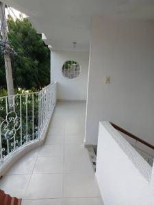 a white hallway with a balcony with a window at Apartamento amplio, confortable aire acondicionado in Ríohacha