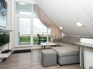 ein Wohnzimmer mit einem Sofa und einem großen Fenster in der Unterkunft 6 person holiday home in Wendtorf in Wendtorf