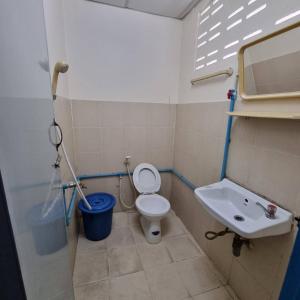 La petite salle de bains est pourvue de toilettes et d'un lavabo. dans l'établissement Sorworakit Hotel, à Bang Saen