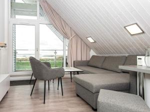 a living room with a couch and a table at 4 person holiday home in Wendtorf in Wendtorf