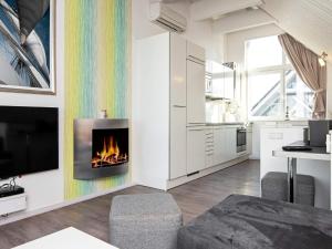 a living room with a fireplace in the wall at Two-Bedroom Holiday home in Wendtorf 19 in Wendtorf