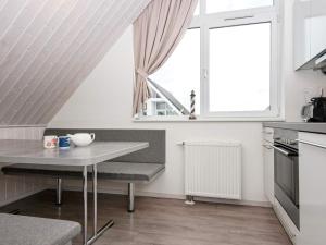 a white kitchen with a table and a window at 4 person holiday home in Wendtorf in Wendtorf