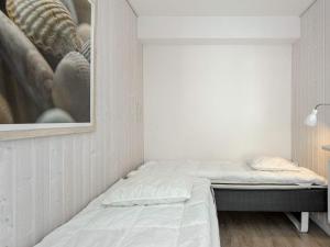 a bedroom with a bed and a painting on the wall at Holiday Home Strandblick in Wendtorf