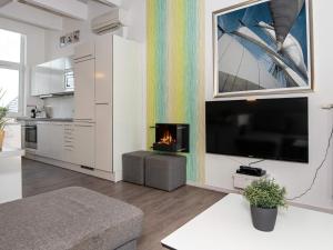 a living room with a fireplace and a tv at 6 person holiday home in Wendtorf in Wendtorf