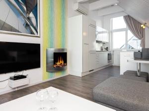 a living room with a fire place in the wall at Holiday Home Strandblick II in Wendtorf