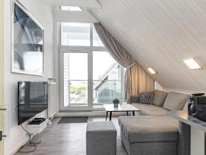 a living room with a couch and a tv at 4 person holiday home in Wendtorf in Wendtorf