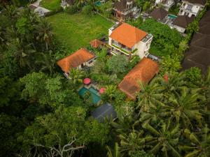 an aerial view of a house with a pool and trees at Villa Ubud Sunshine in Ubud