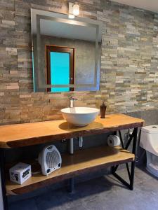 a bathroom with a sink and a mirror at Hospedaje Neyün La Junta in La Junta