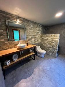 a bathroom with a sink and a toilet at Hospedaje Neyün La Junta in La Junta