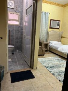 a bathroom with a shower and a bathroom with a toilet at سويتات مفروشة in Al Hofuf