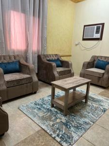 a living room with two couches and a coffee table at سويتات مفروشة in Al Hofuf
