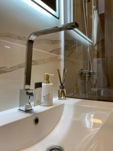 a bathroom sink with a faucet on a counter at King Milans Apartment in Belgrade +5 photos