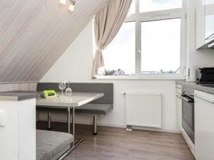 a small kitchen with a table and a window at 6 person holiday home in Wendtorf in Wendtorf
