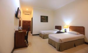 Postel nebo postele na pokoji v ubytování Lombok Garden Hotel