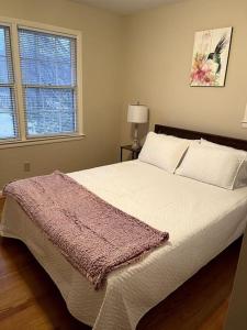a bedroom with a bed with a purple blanket on it at You won't want to leave! in Huntsville