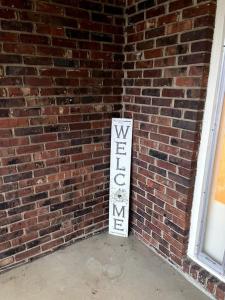 a brick wall with a sign on the side of it at You won't want to leave! in Huntsville