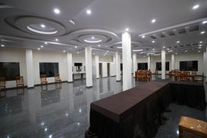 a large room with a table and chairs in it at Lazo Coffee Bean Resort in Madikeri