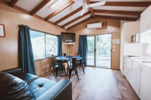 a living room with a couch and a table at BIG4 Breeze Holiday Parks - Cania Gorge in Cania