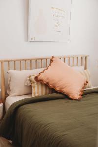 a bed with two pillows on top of it at Alma at Shoal Bay in Shoal Bay