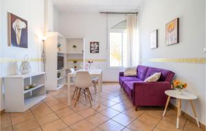 a living room with a purple couch and a table at Nice Apartment In Baena With Kitchenette in Baena