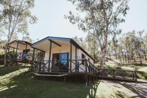 a house in the middle of a field with trees at BIG4 Breeze Holiday Parks - Cania Gorge in Cania