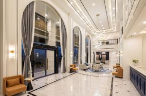 a lobby with chairs and tables in a building at Eastin Hotel Vientiane in Vientiane