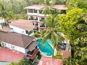 an aerial view of a resort with a swimming pool at The Verda De Miranda Resort Morjim North Goa in Morjim