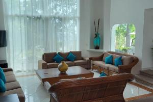 a living room with two couches and a coffee table at Villa Martha Garza Blanca - Heated Pool, Chef & Full Staff Included in Puerto Vallarta