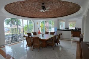 a dining room table with chairs and a ceiling at Villa Martha Garza Blanca - Heated Pool, Chef & Full Staff Included in Puerto Vallarta