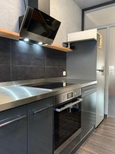 a kitchen with stainless steel appliances and a stove at Vivi in Wolfenbüttel