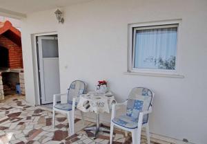 a dining room with a table and two chairs at Apartments Tomislav - 120 m from beach in Okrug Donji