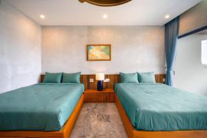 Postel nebo postele na pokoji v ubytování Bon Sand Villa & Spa Hoi An